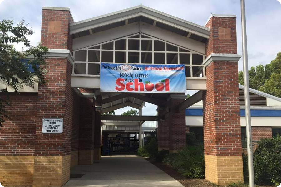 front of school building with a back to school banner